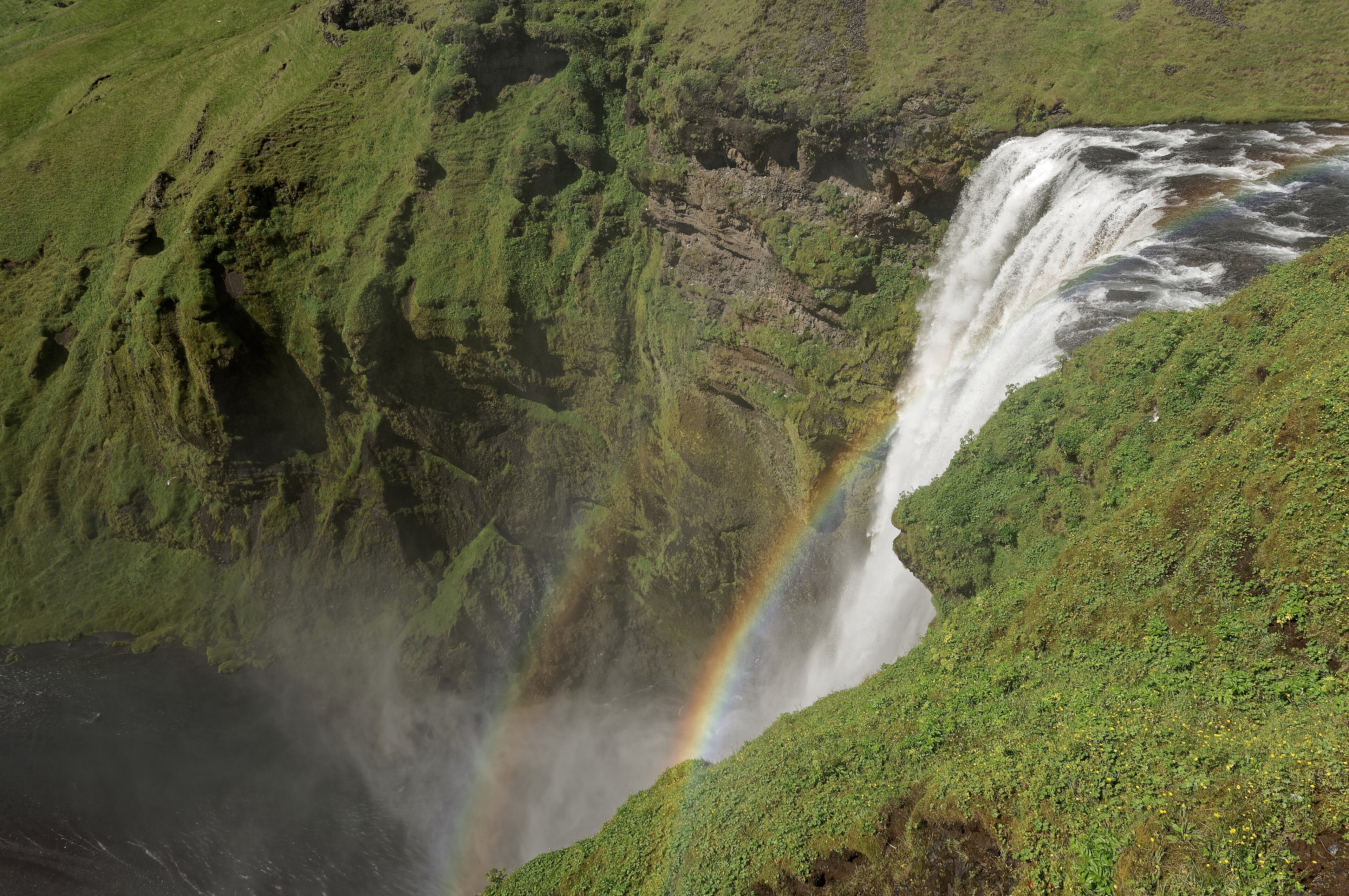 Skógafoss, a wide curtain of water falling from the former sea cliffs at Skógar